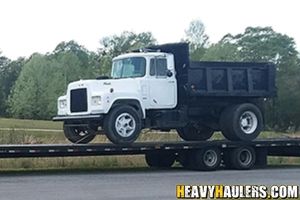 Transporting a dump truck on a hot shot trailer.