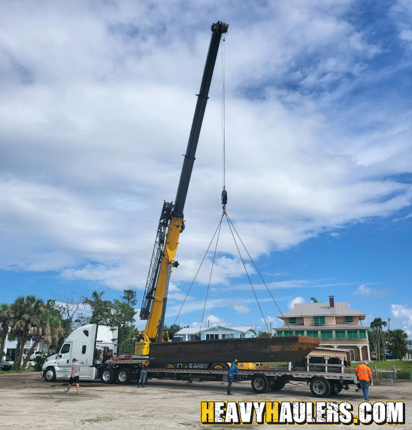 Oversize Wilson Conveyor on an RGN trailer.