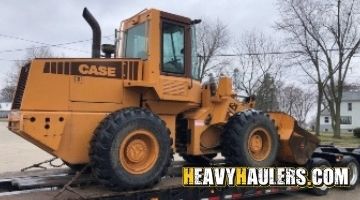 Strapping a Case backhoe for transport.