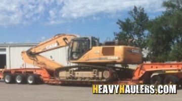 Loading a Case excavator on a trailer.