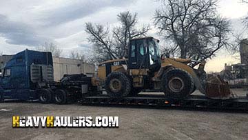 Shipping a Caterpillar 950G wheel loader on a trailer.