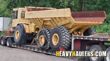 Loading a Caterpillar dump truck on a trailer.