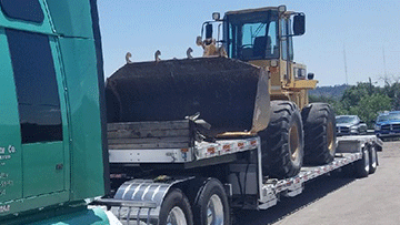 Drop deck trailer used to ship a wheel loader.