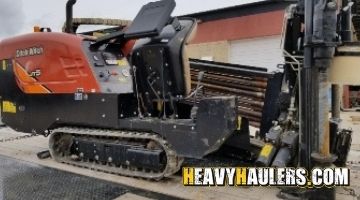 Loading a Ditch Witch directional drill on a trailer.