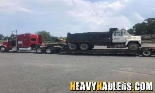 Dump truck transport on an RGN trailer.