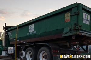 2010 Mack Roll Off dump truck shipped on a step deck trailer.