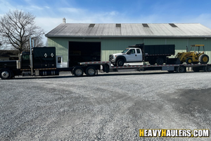 2016 Ford f550 single axle dump trump loaded on a step deck trailer.