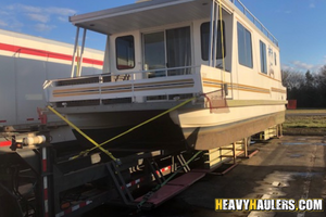 Transportation of a house boat.