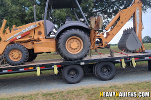 Shipping a Case 580 Super M Backhoe w/ 3 attachments on a trailer.