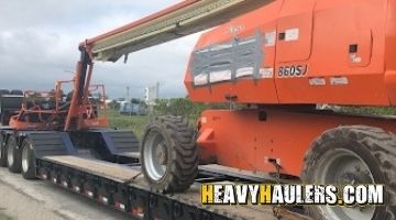 Shipping a boom lift on a double drop trailer.