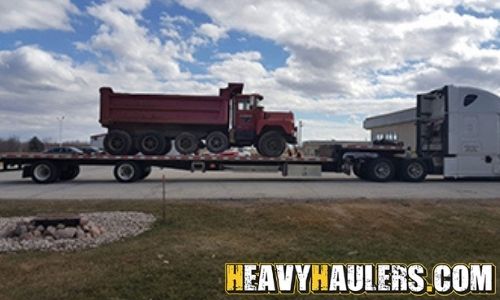 Shipping a dump truck on a step deck trailer.