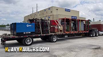Miller standby generator loaded on a step deck trailer.