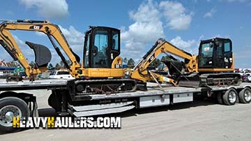 Hauling two Caterpillar excavators.