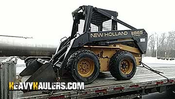Moving a New Holland skid steer.