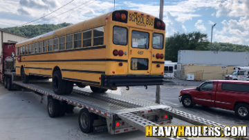 shipping a school bus on a step deck trailer